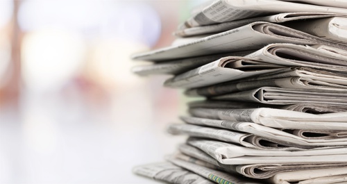 Stack of newspapers on background